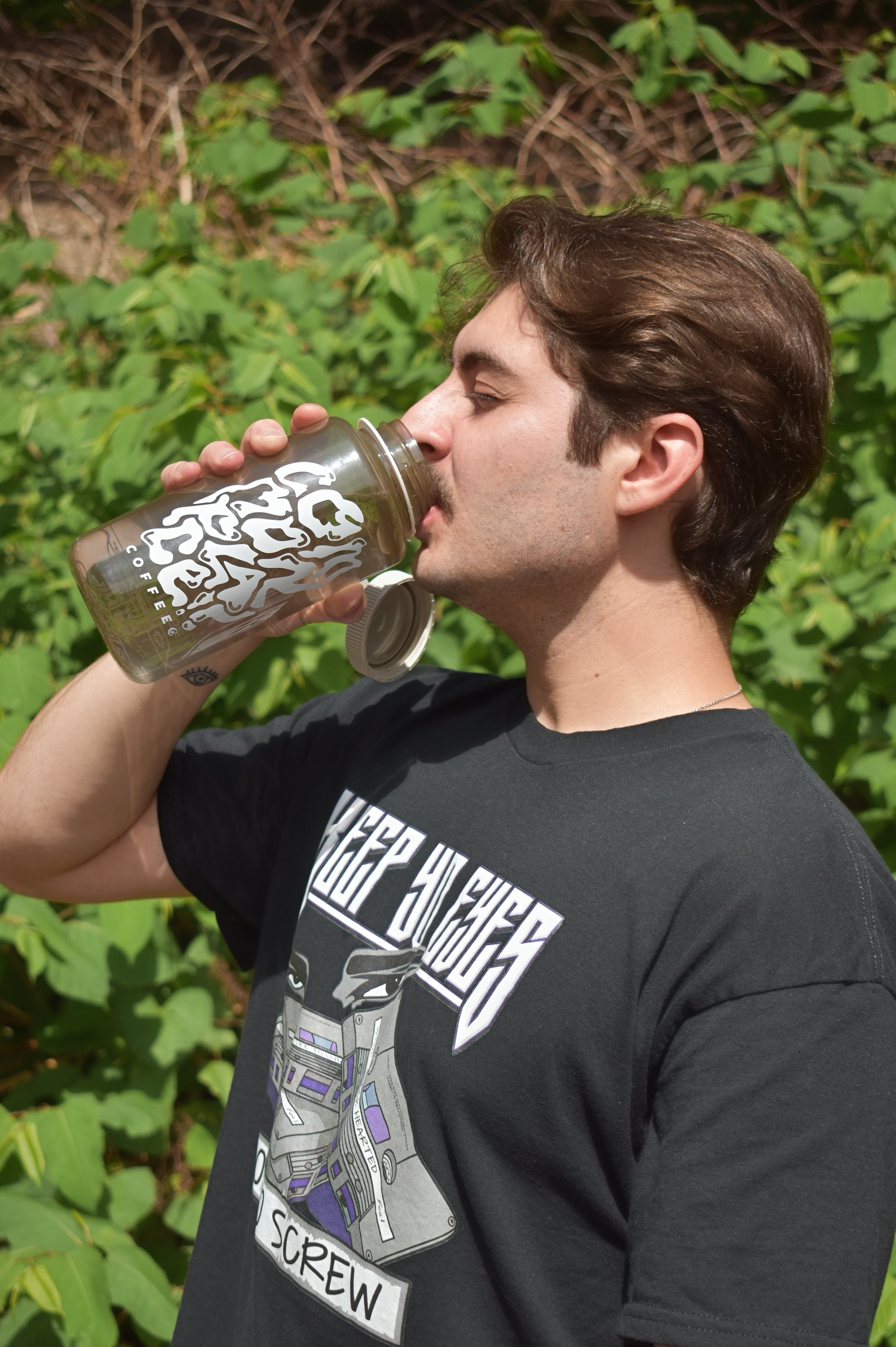 Picture of someone drinking out of 32oz Commonplace Nalgene Water Bottle