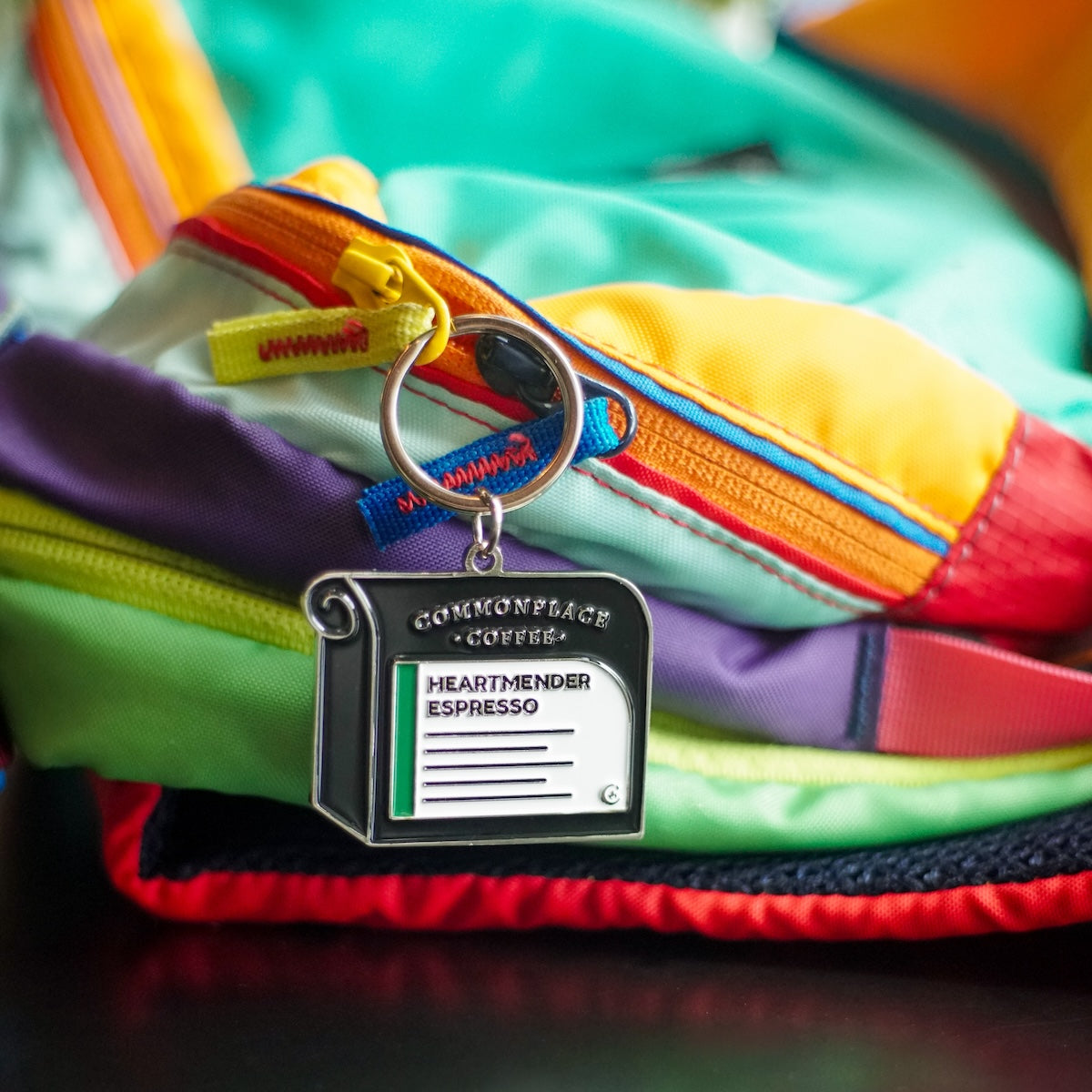 A keychain designed to look like a bag of Commonplace Coffee's Heartmender Espresso