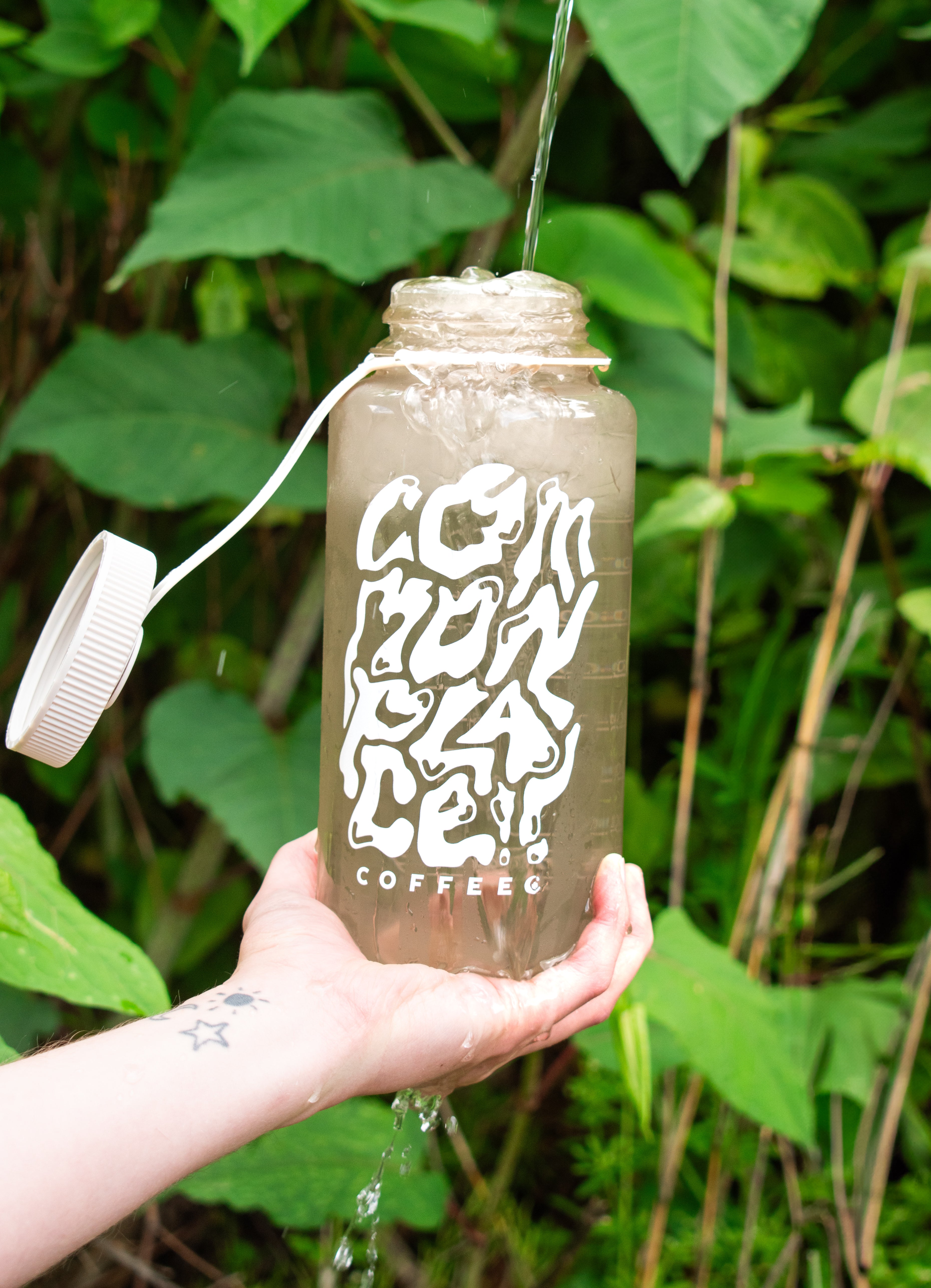 Picture of water being poured into a 32oz Commonplace Nalgene Water Bottle