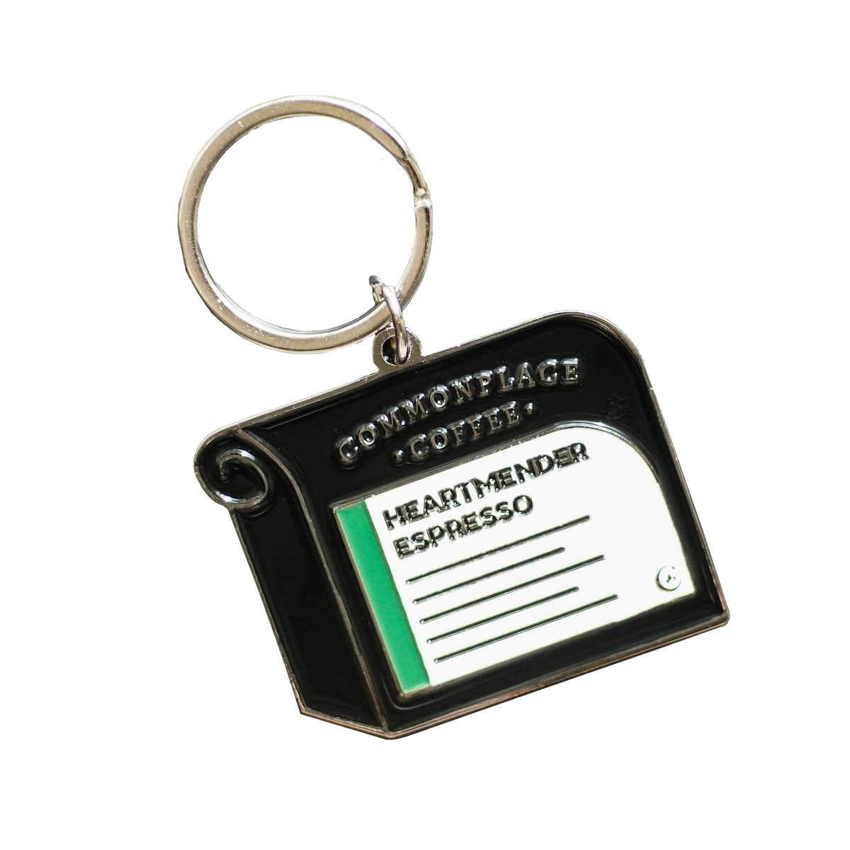 Front side of an enamel keychain styled to look like a retail bag of Commonplace Coffee's Heartmender Espresso. 