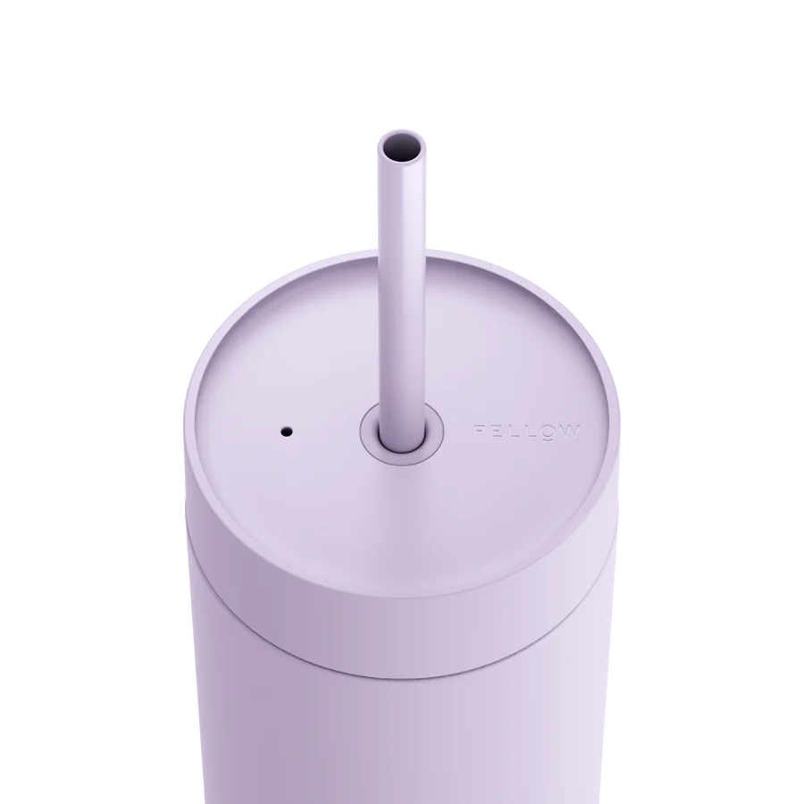 The top of a light purple travel mug, featuring a lid and straw. 