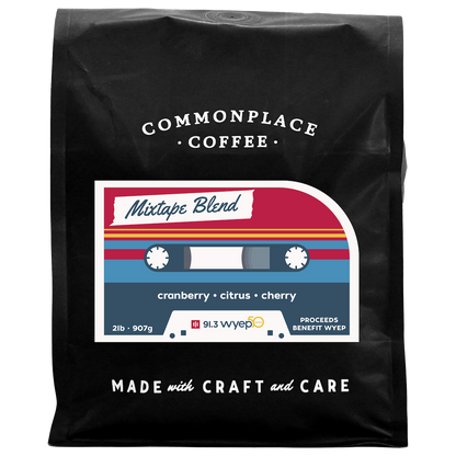 A black bag of 2lb Mixtape Blend from Commonplace Coffee. The label is red, yellow, and blue, and looks like a retro cassette tape.